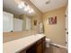 Neutral bathroom features a large vanity mirror, a white sink and a shower-tub combination at 8644 N Deer Crossing Blvd, McCordsville, IN 46055