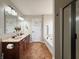 Bathroom featuring double sinks, soaking tub, shower, and vanity with dark wood cabinets at 8644 N Deer Crossing Blvd, McCordsville, IN 46055