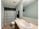 Bathroom features a shower-tub combination with a black and white shower curtain, with a neutral vanity at 8644 N Deer Crossing Blvd, McCordsville, IN 46055