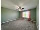 Spacious bedroom with carpet, ceiling fan, and natural light from the window at 8644 N Deer Crossing Blvd, McCordsville, IN 46055