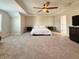 Spacious bedroom with carpet, ceiling fan, and natural light from the window at 8644 N Deer Crossing Blvd, McCordsville, IN 46055