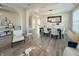 Modern dining area with hardwood floors, stylish table setting, open-concept design, and a cozy living space at 8644 N Deer Crossing Blvd, McCordsville, IN 46055