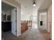 Upstairs hallway with carpet and wood banister has access to various rooms at 8644 N Deer Crossing Blvd, McCordsville, IN 46055