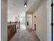 Open hallway that flows into a carpeted living room with a ceiling fan and lots of natural light at 8644 N Deer Crossing Blvd, McCordsville, IN 46055