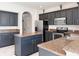 Spacious kitchen with dark cabinets, granite countertops and stainless steel appliances at 8644 N Deer Crossing Blvd, McCordsville, IN 46055