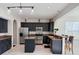 Modern kitchen featuring dark cabinets, stainless steel appliances, and granite countertops at 8644 N Deer Crossing Blvd, McCordsville, IN 46055