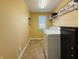 Bright laundry room features a window, shelving, and modern washer and dryer at 8644 N Deer Crossing Blvd, McCordsville, IN 46055