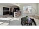 Comfortable seating area featuring kitchen bar, bright windows, and modern appliances at 8644 N Deer Crossing Blvd, McCordsville, IN 46055