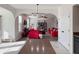 Open concept living room featuring tile floors, a red couch, and bright lighting at 8644 N Deer Crossing Blvd, McCordsville, IN 46055