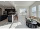 Cozy living area with kitchen, bar seating, bright lighting, and comfortable seating at 8644 N Deer Crossing Blvd, McCordsville, IN 46055