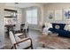 Open-concept living room and dining area with stylish furnishings, hardwood floors, and lots of natural light at 8644 N Deer Crossing Blvd, McCordsville, IN 46055