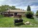 Well-maintained backyard with deck, brick house, and a lush green lawn, great for relaxation and outdoor enjoyment at 9521 Gemini Dr, Indianapolis, IN 46229