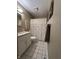 Well-lit bathroom with a single sink vanity, white toilet, and shower with decorative curtain at 9521 Gemini Dr, Indianapolis, IN 46229