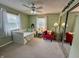 Bright bedroom with large windows, daybed, and comfortable red chair at 9521 Gemini Dr, Indianapolis, IN 46229