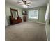 Empty bedroom with neutral carpet, green walls, and large windows at 9521 Gemini Dr, Indianapolis, IN 46229
