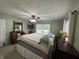 Bedroom features green walls, ceiling fan and a large window with blinds and curtains at 9521 Gemini Dr, Indianapolis, IN 46229