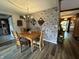 Inviting dining room with floral wallpaper, hardwood floors, and an elegant chandelier for intimate gatherings at 9521 Gemini Dr, Indianapolis, IN 46229