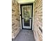Close-up of a home's exterior featuring a decorative glass front door set in a brick facade at 9521 Gemini Dr, Indianapolis, IN 46229
