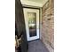 Close-up of a home's exterior featuring a decorative glass front door set in a brick facade at 9521 Gemini Dr, Indianapolis, IN 46229