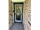 Inviting brick entryway featuring a black security door and patterned welcome mat at 9521 Gemini Dr, Indianapolis, IN 46229