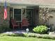 Inviting front porch with comfortable seating and blooming flowers at 9521 Gemini Dr, Indianapolis, IN 46229