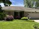 Charming ranch home featuring a well-manicured lawn, brick facade and an attached two car garage at 9521 Gemini Dr, Indianapolis, IN 46229