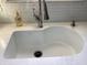 A close up of a white kitchen sink with stainless steel faucet and white mosaic backsplash at 9521 Gemini Dr, Indianapolis, IN 46229