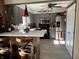 Stylish kitchen with stainless steel appliances, gray cabinets, and a breakfast bar for casual dining at 9521 Gemini Dr, Indianapolis, IN 46229