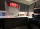 Gray kitchen with gray cabinets, stainless steel appliances, mosaic backsplash, and red accents at 9521 Gemini Dr, Indianapolis, IN 46229