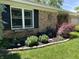 Brick house with well manicured landscaping and black shutters at 9521 Gemini Dr, Indianapolis, IN 46229