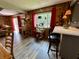 Open-concept living area with wood paneling, hardwood floors, bar stool seating, and natural light at 9521 Gemini Dr, Indianapolis, IN 46229