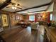 Inviting living room with wood paneled walls, beamed ceiling, and hardwood floors offers a cozy atmosphere at 9521 Gemini Dr, Indianapolis, IN 46229