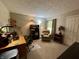Cozy office space with a desk, chair, bookshelf, lamp and comfortable armchair at 9521 Gemini Dr, Indianapolis, IN 46229
