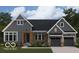 Charming home featuring a dark gray facade, stone accents, and a well-manicured lawn at 963 Apryl Dr, Greenwood, IN 46143