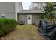 View of the home's exterior showing siding and the backyard with mature bushes at 10764 Northhampton Dr, Fishers, IN 46038