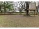 Back yard featuring a wooden fence, mature trees, and a custom treehouse at 10764 Northhampton Dr, Fishers, IN 46038