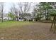 Expansive back yard with mature trees and a charming screened porch attached to the home at 10764 Northhampton Dr, Fishers, IN 46038