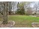 Back yard featuring a custom treehouse, mature trees, and a well-manicured lawn at 10764 Northhampton Dr, Fishers, IN 46038