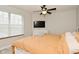 Cozy bedroom with a ceiling fan, and large window for natural light at 10764 Northhampton Dr, Fishers, IN 46038