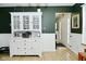 Charming dining area with white hutch and view of entryway, offering a cozy space for meals at 10764 Northhampton Dr, Fishers, IN 46038