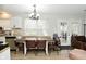Open-concept dining area with natural light, featuring a long table with seating for Gathering meals at 10764 Northhampton Dr, Fishers, IN 46038