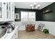 Bright dining area featuring a wooden table, playroom area, and natural light from a large window at 10764 Northhampton Dr, Fishers, IN 46038
