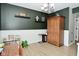 Charming dining room featuring dark green walls, wood-look flooring and an attractive hutch at 10764 Northhampton Dr, Fishers, IN 46038