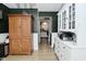 Hallway showcases a wooden hutch, white cabinets and dark green walls at 10764 Northhampton Dr, Fishers, IN 46038