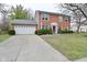Two-story brick home featuring an attached two-car garage and a well-manicured front yard at 10764 Northhampton Dr, Fishers, IN 46038