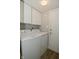 Bright laundry area features white appliances, cabinets, and wood-look flooring at 10764 Northhampton Dr, Fishers, IN 46038
