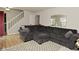 Inviting living room featuring a comfortable gray sectional and a stylish modern mirror at 10764 Northhampton Dr, Fishers, IN 46038