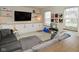 Cozy living room includes built-in shelves, a gray sectional, and play area at 10764 Northhampton Dr, Fishers, IN 46038
