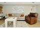 Cozy living room with comfortable seating, accent rug, and bright white walls at 10764 Northhampton Dr, Fishers, IN 46038