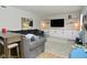 Comfortable living room features built-in shelving, a large TV, and a plush gray sectional sofa at 10764 Northhampton Dr, Fishers, IN 46038